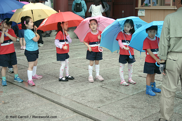 Korean schoolkids with colorful umbrellas