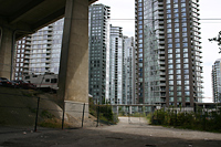 Vehicles parked near new housing towers